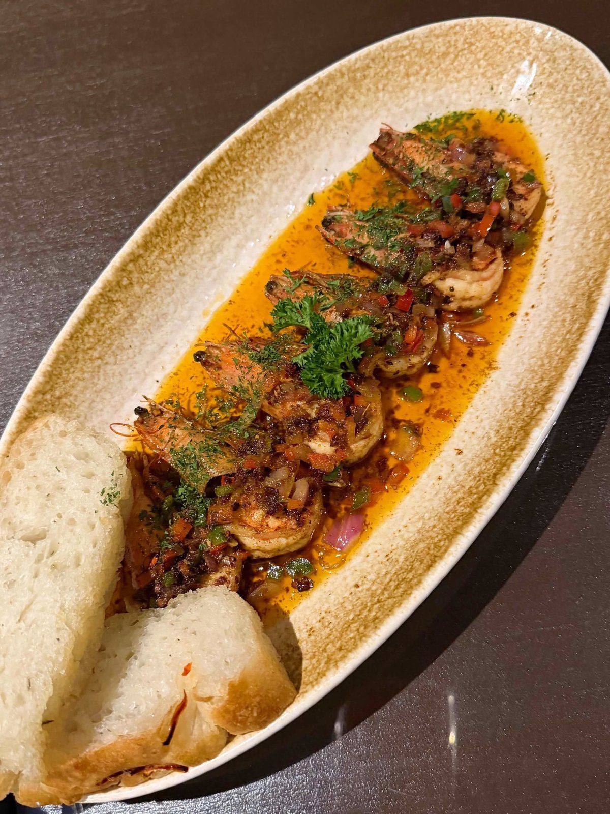 Shrimp in an orange garlic sauce served with bread