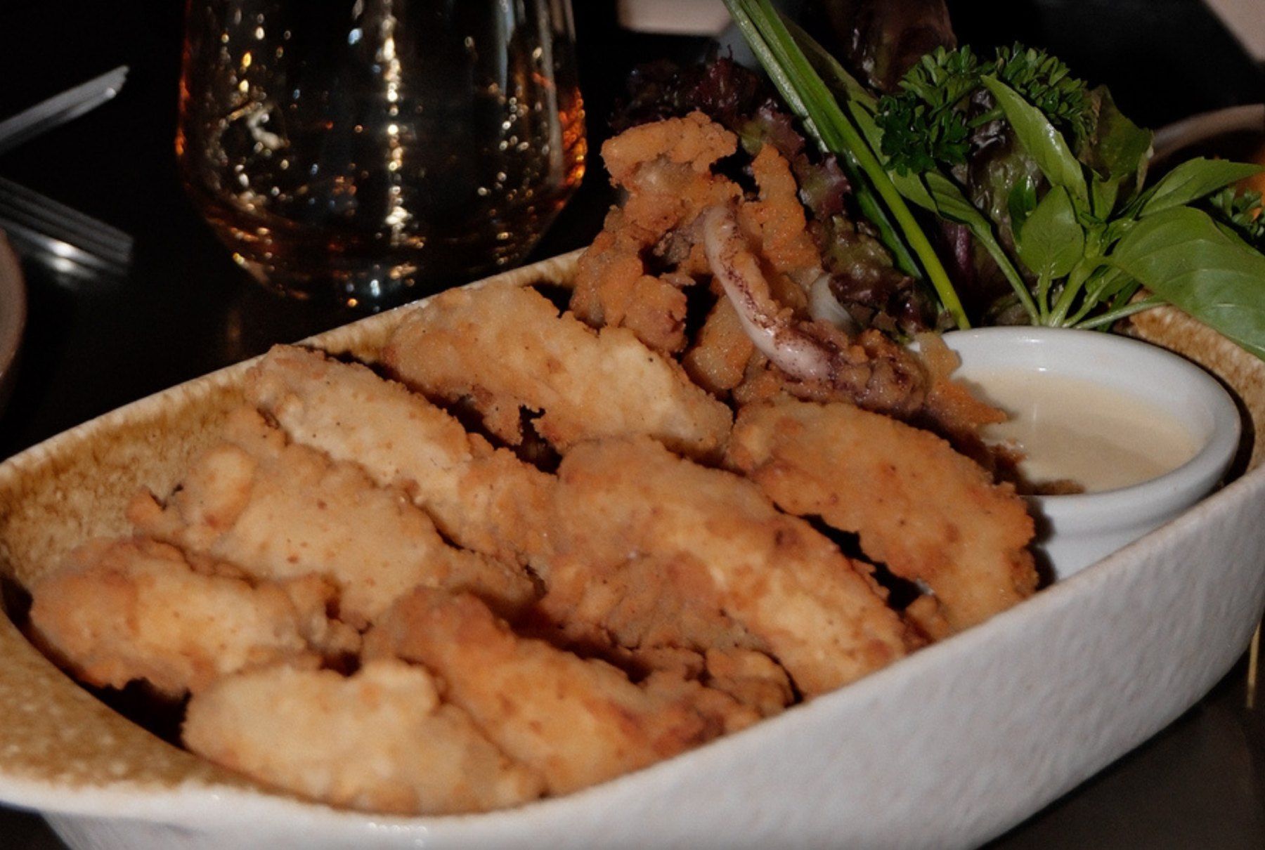 Golden crispy calamari rings with a dip