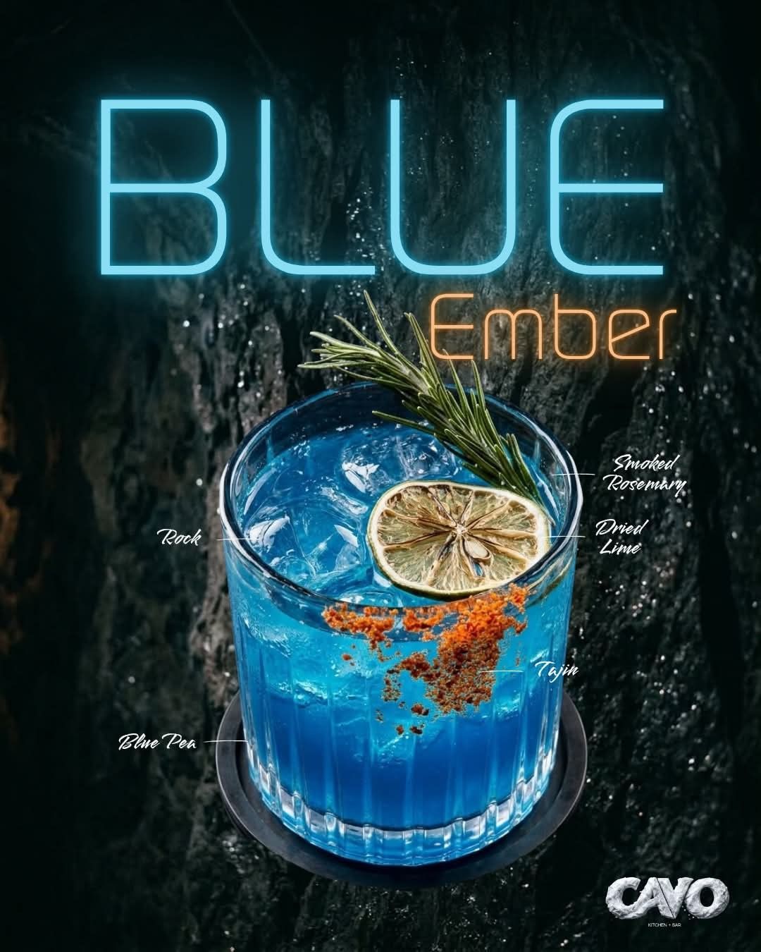 Cavo's Blue Ember: a blue cocktail with dried lime and rosemary on dark stone